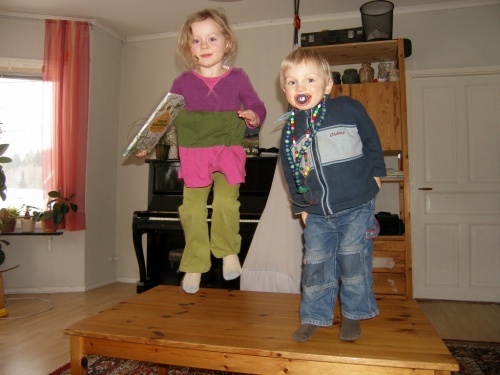 Two little monkeys jumping on the table